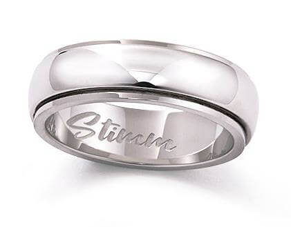Surgical stainless steel jewelry rings and bracelets on neutral background